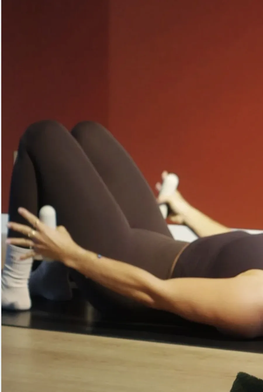 A client working through a reformer exercise in the studio